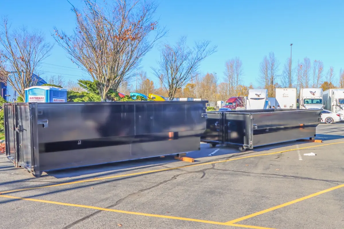 Professional dumpster rental service with roll-off container on residential driveway in Notre Dame